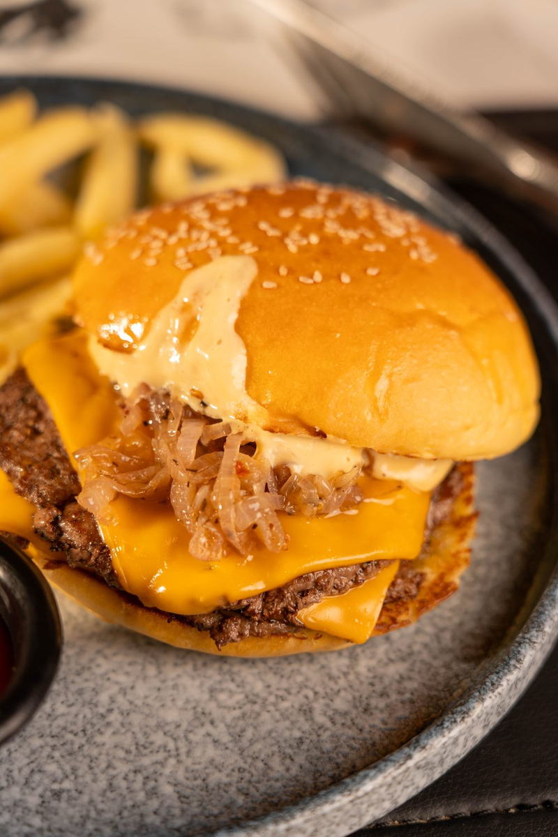 Seared beef patties with melted cheese and caramelised onions
